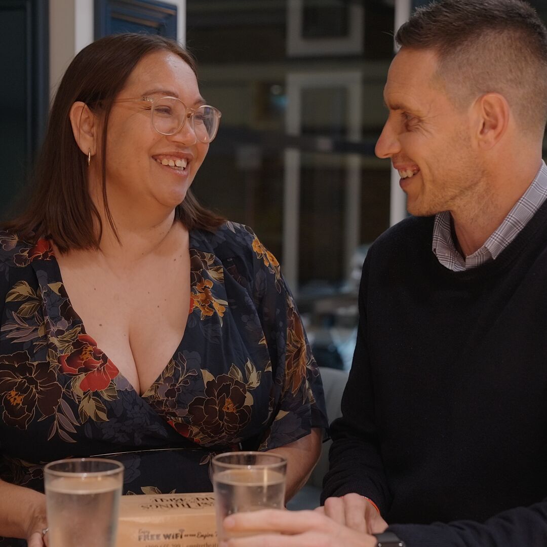 Two members having a drink by the bar