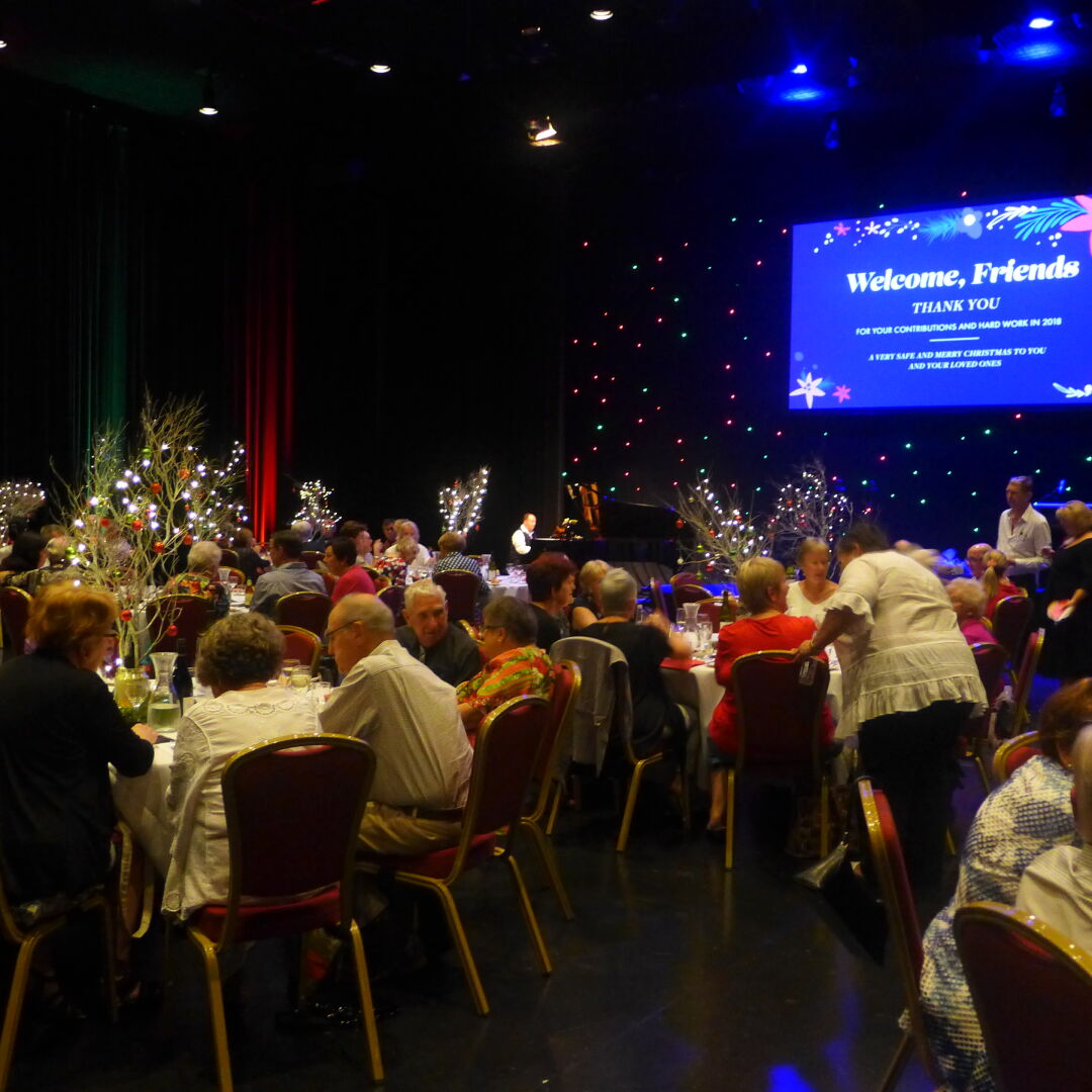 Empire volunteers sitting at circular tables at a celebratory function