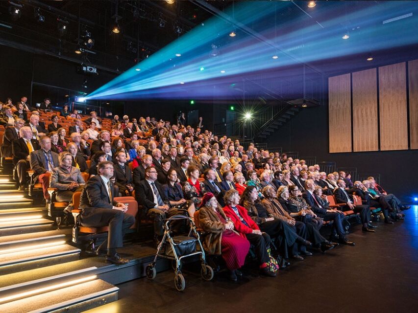 Large audience enjoying performance. 