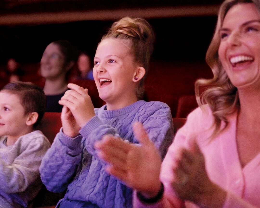 Family clapping along with the show