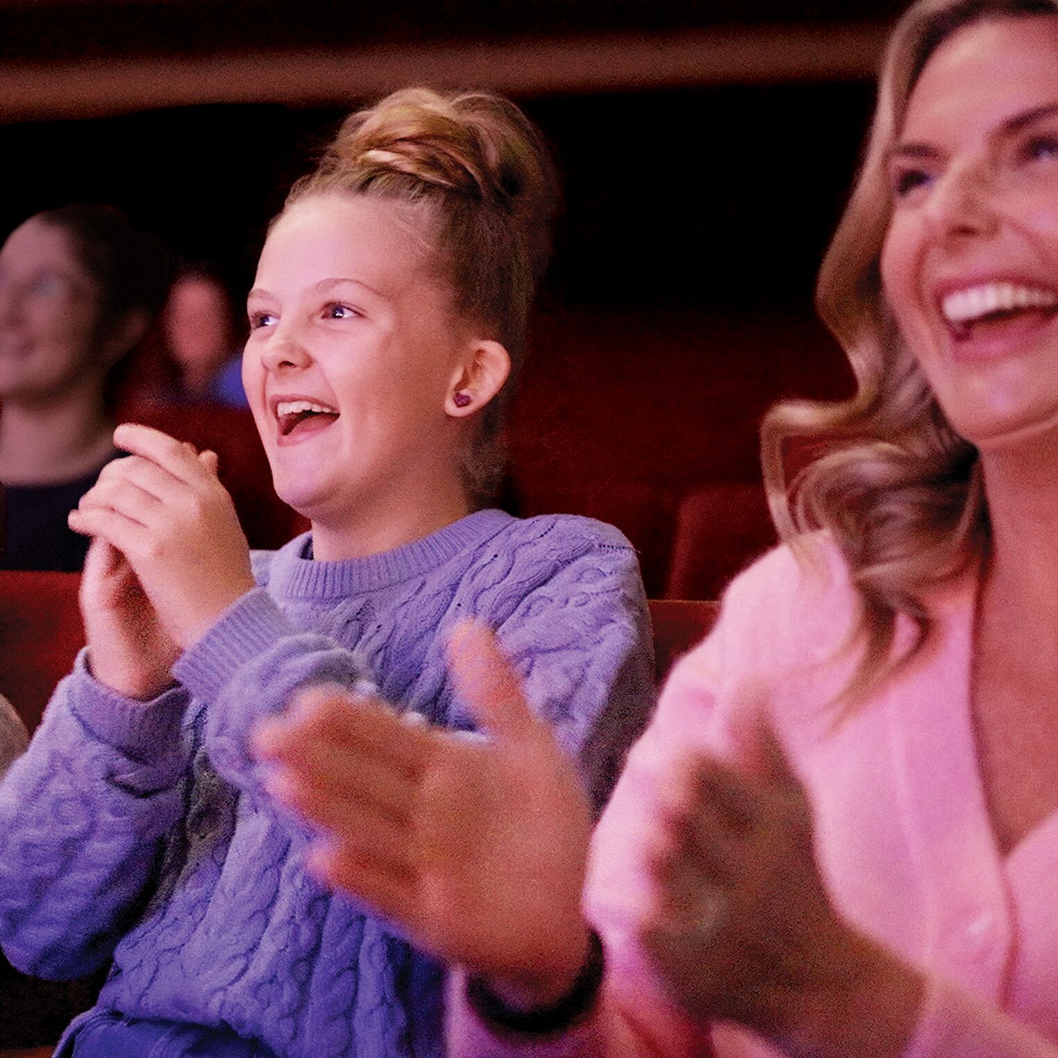 Family clapping along with the show