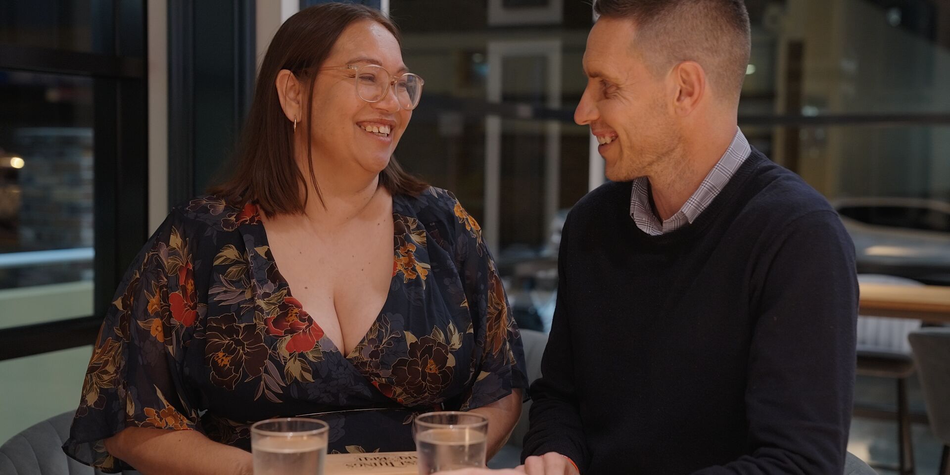 Two members having a drink by the bar