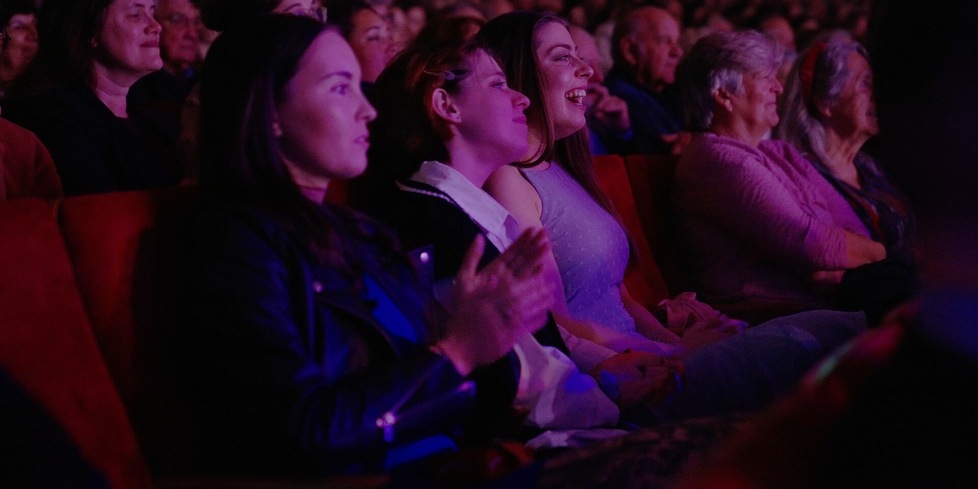 Audience members enjoying performance