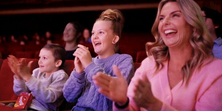 Family clapping along with the show